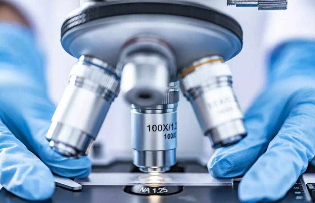 A medical worker performs capillary blood analysis on a portable device