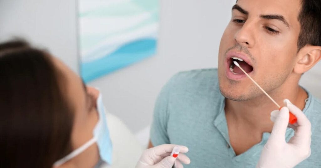 man holding a test tube with saliva for a DNA test