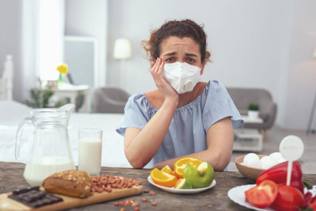 girl with allergies holding a plate without food