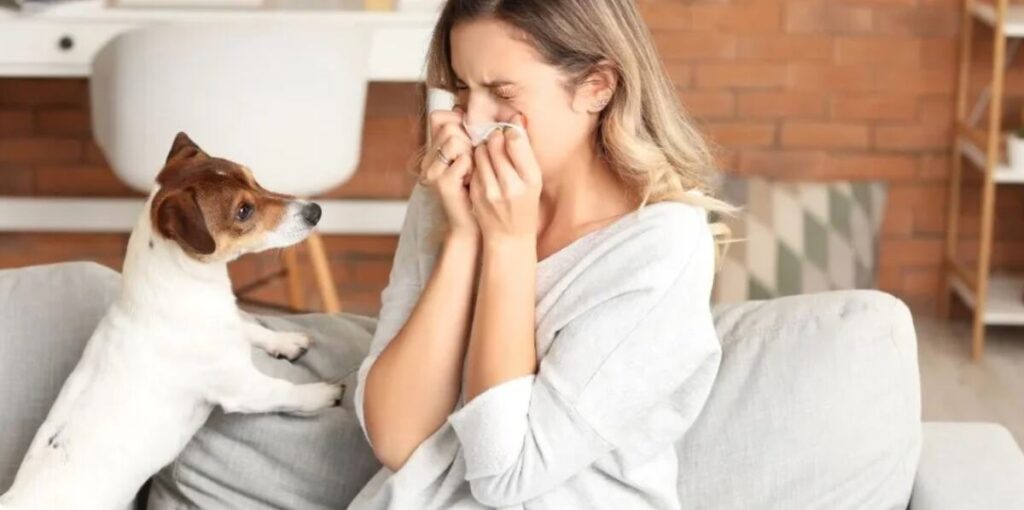 Child with allergy symptoms next to dog