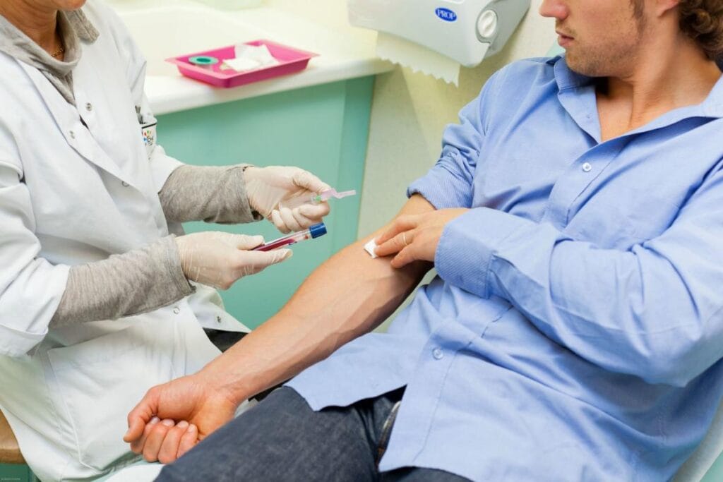 A man fills out a questionnaire before taking tests at a clinic.