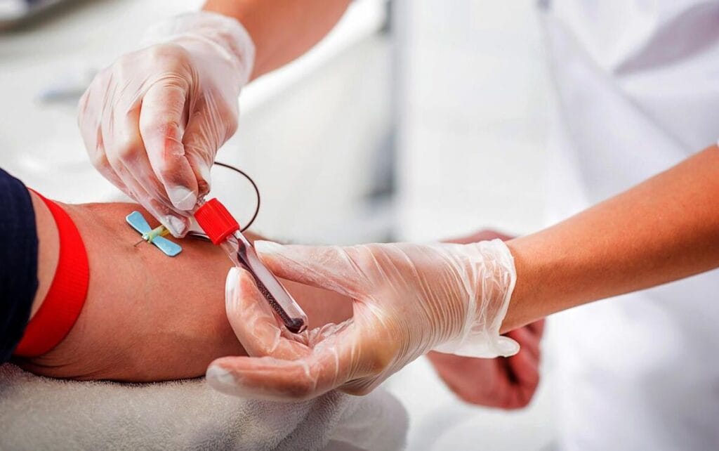 A nurse takes blood for hormone analysis