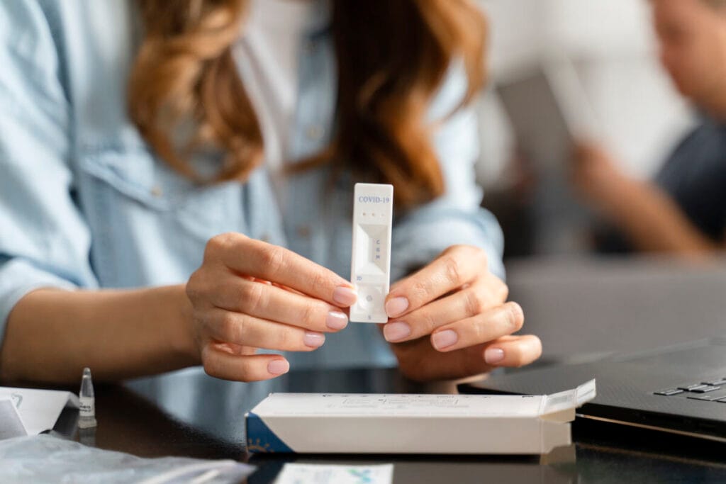 A nurse is performing a rapid test on a patient in the office.